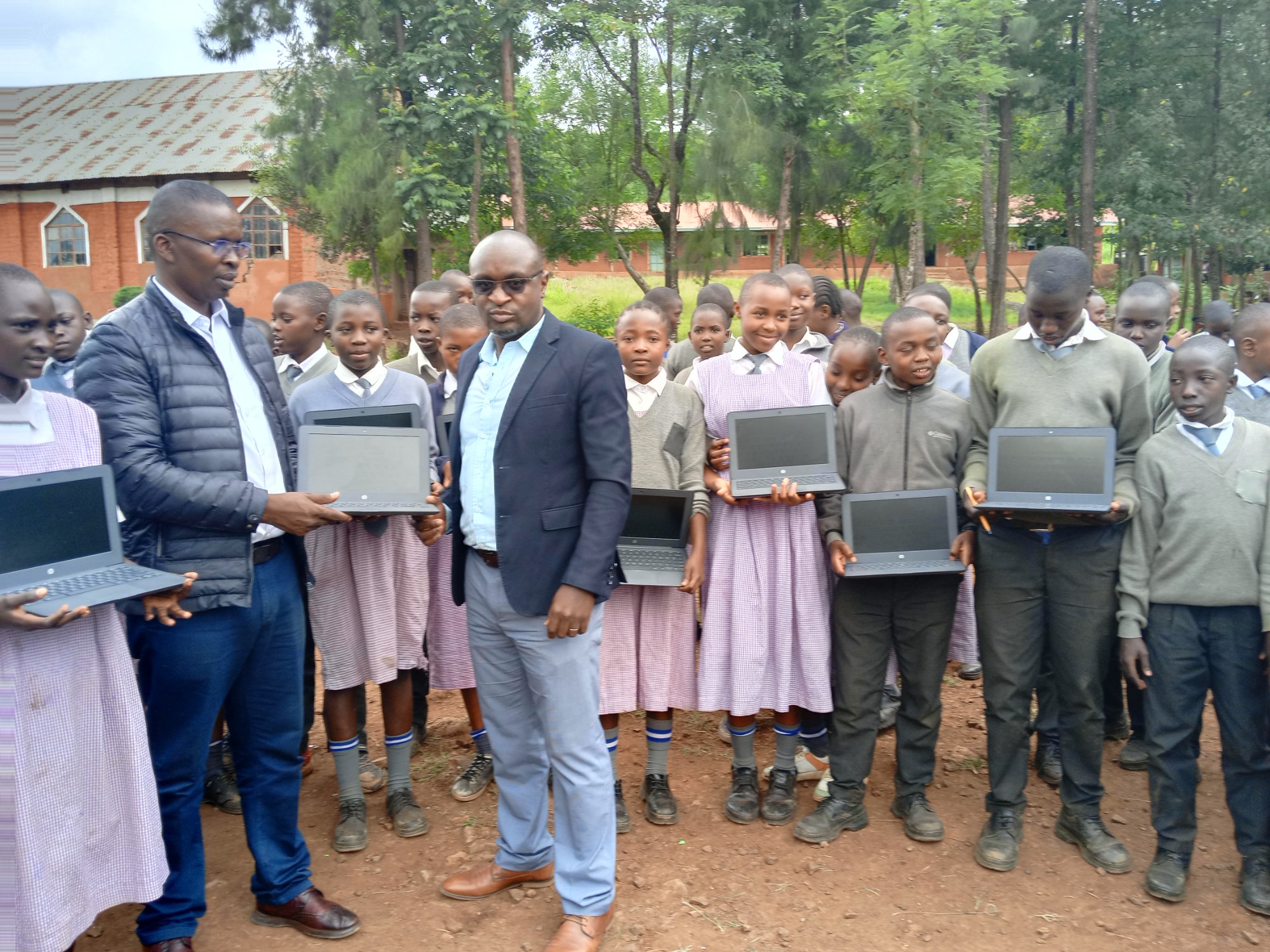 Students holding laptops at school deployment